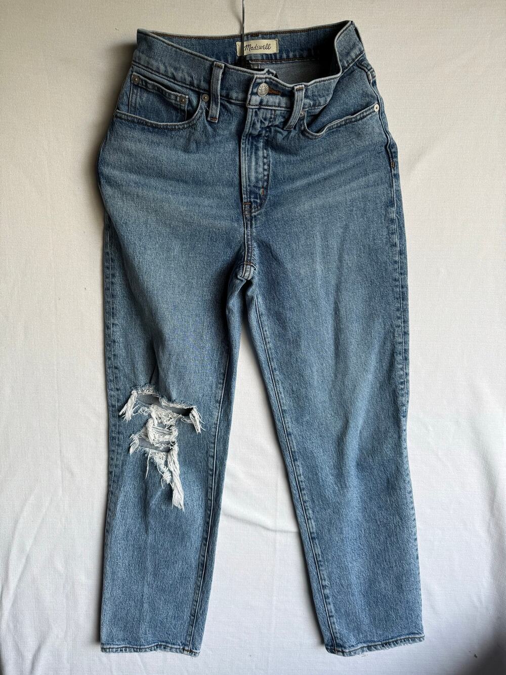 Madewell high-rise straight-leg jeans with distressing on the right knee